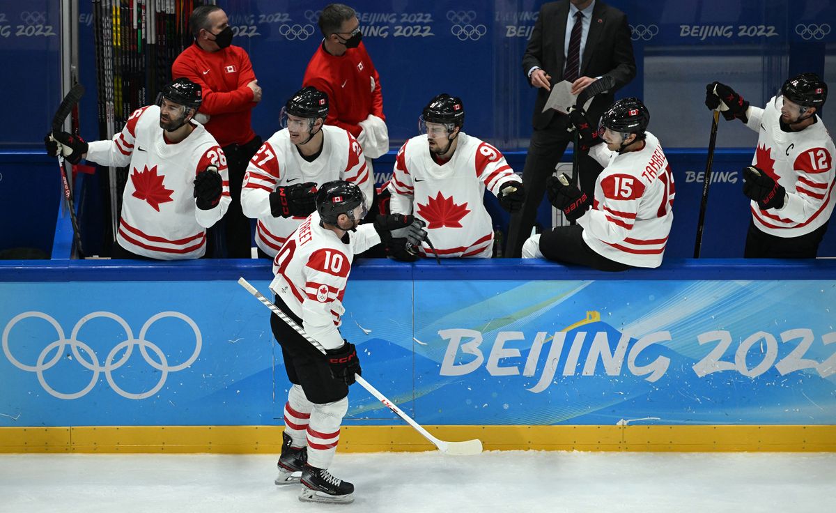 Canada's Benjamin Street celebrates with teammates after scoring the team's first goal against China during their men's preliminary round group A match of the Beijing 2022 Winter Olympic Games ice hockey competition, at the National Indoor Stadium in Beijing on February 13, 2022. 