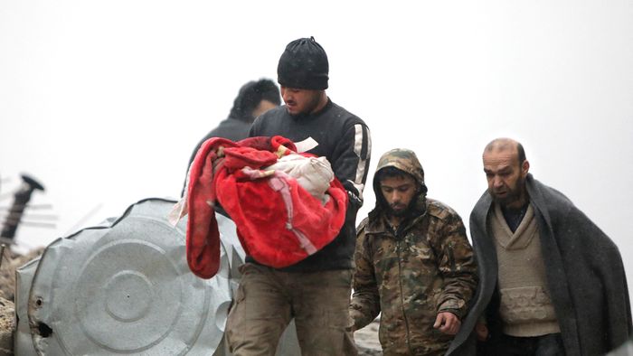 EDITORS NOTE: Graphic content / A Syrian man carries the body of an infant who was killed in an earthquake in the town of Jandaris, in the countryside of Syria's northwestern city of Afrin in the rebel-held part of Aleppo province, on February 6, 2023. - Hundreds have been reportedly killed in north Syria after a 7.8-magnitude earthquake that originated in Turkey and was felt across neighbouring countries. (Photo by Bakr ALKASEM / AFP)