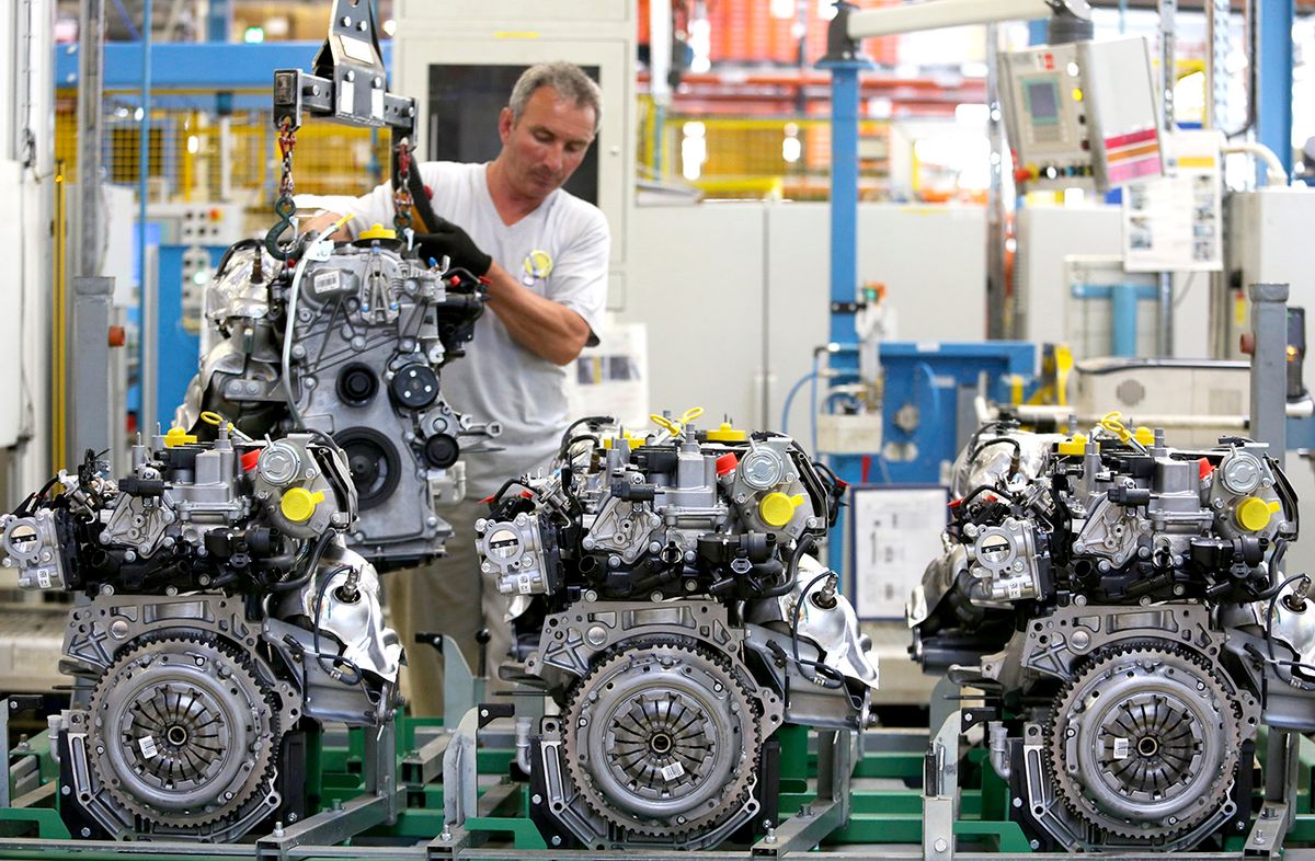 Inside A Renault Dacia Plant As Vehicles Leave The Production Line
An employee lowers a completed petrol engine on to racking at the Renault Dacia factory, in Pitesti, Romania, on Thursday, July 3, 2014. European car sales rose 4.3 percent in May, the ninth consecutive monthly gain, as growing consumer confidence encouraged purchases of new models from Renault SA, Volkswagen AG and General Motors Co. Photographer: Chris Ratcliffe/Bloomberg via Getty Images