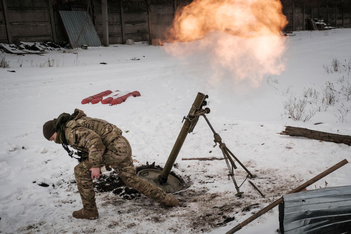 A Ukrainian serviceman of the State Border Guard Service fires a mortar toward the Russian position in Bakhmut on February 16, 2023, as the head of Russia's mercenary outfit Wagner said it could take months to capture the embattled Ukraine city and slammed Moscow's "monstrous bureaucracy" for slowing military gains. - Russia has been trying to encircle the battered industrial city and wrest it ahead of February 24, the first anniversary of what it terms its "special military operation" in Ukraine. 