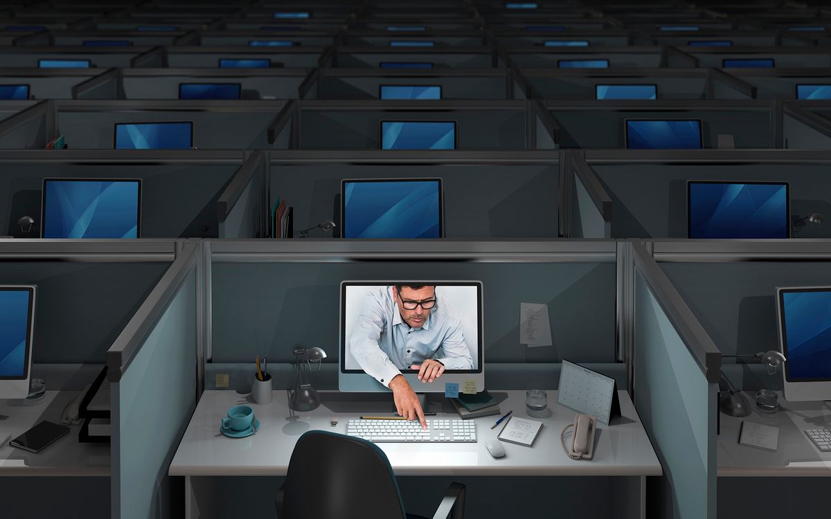 Dark office, one computer on, man touches keyboard