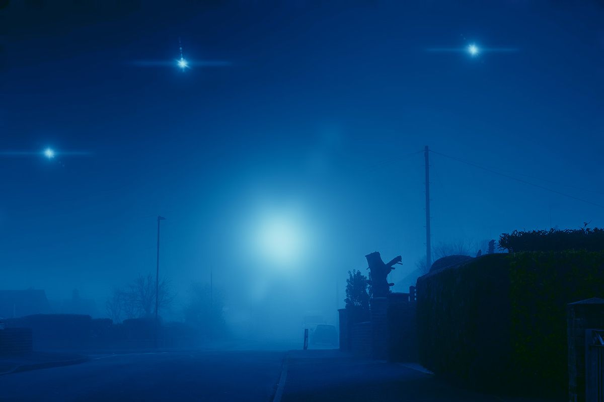 Glowing UFO lights in the sky. In a quiet empty road in a suburban town. On a quiet, atmospheric foggy winters day. UK
Glowing UFO lights in the sky. In a quiet empty road in a suburban town. On a quiet, atmospheric foggy winters day. UK