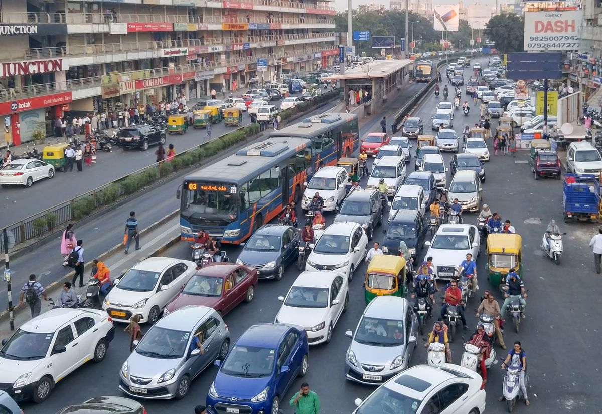 Ahmedabad, India - November 26, 2016: Light volume traffic scene in Ahmedabad. Auto rickshaws and Bus Rapid Transport (BRT) buses provide public transportation.