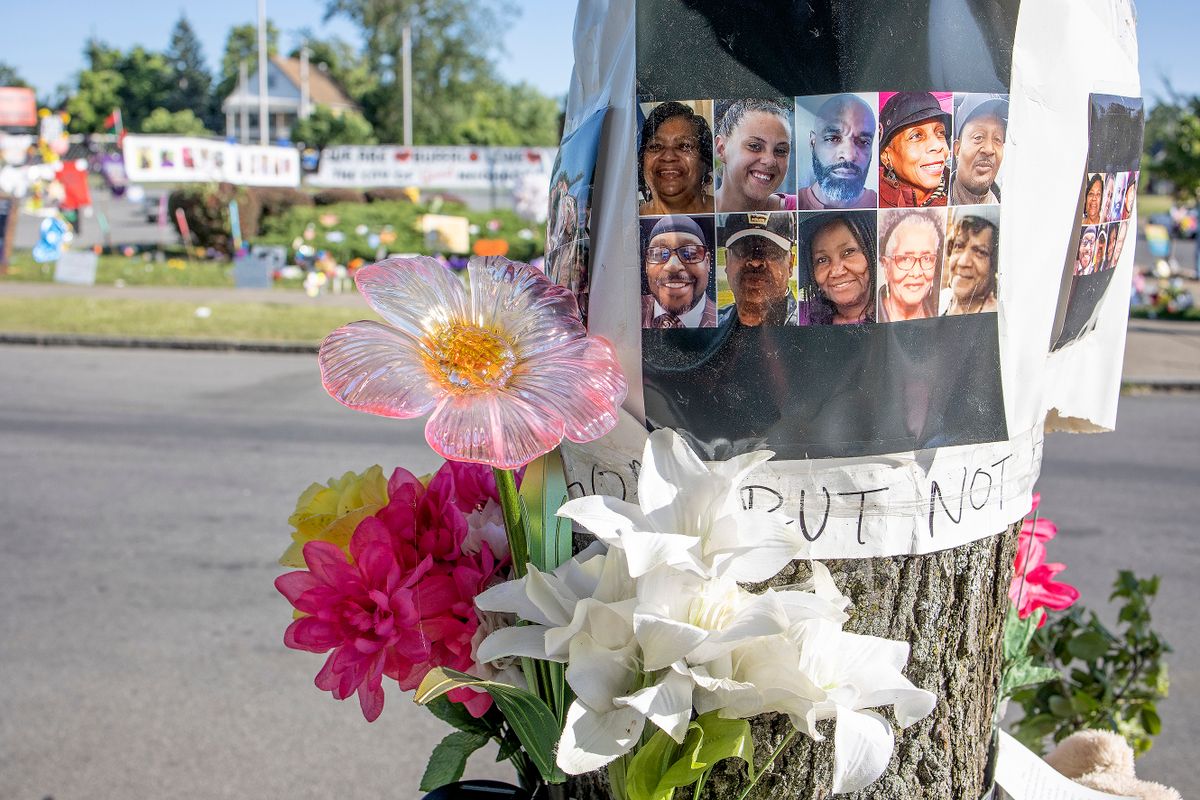 BUFFALO, NEW YORK - JUNE 18: Street memorials of flowers and candles and messages surround the Tops supermarket where a racist gunman murdered ten African Americans with an assault rifle, June 18, 2022 in Buffalo, New York.