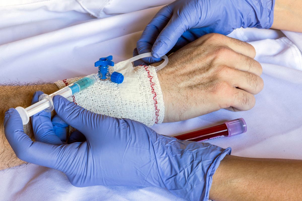 Nurse injecting man with antibiotics