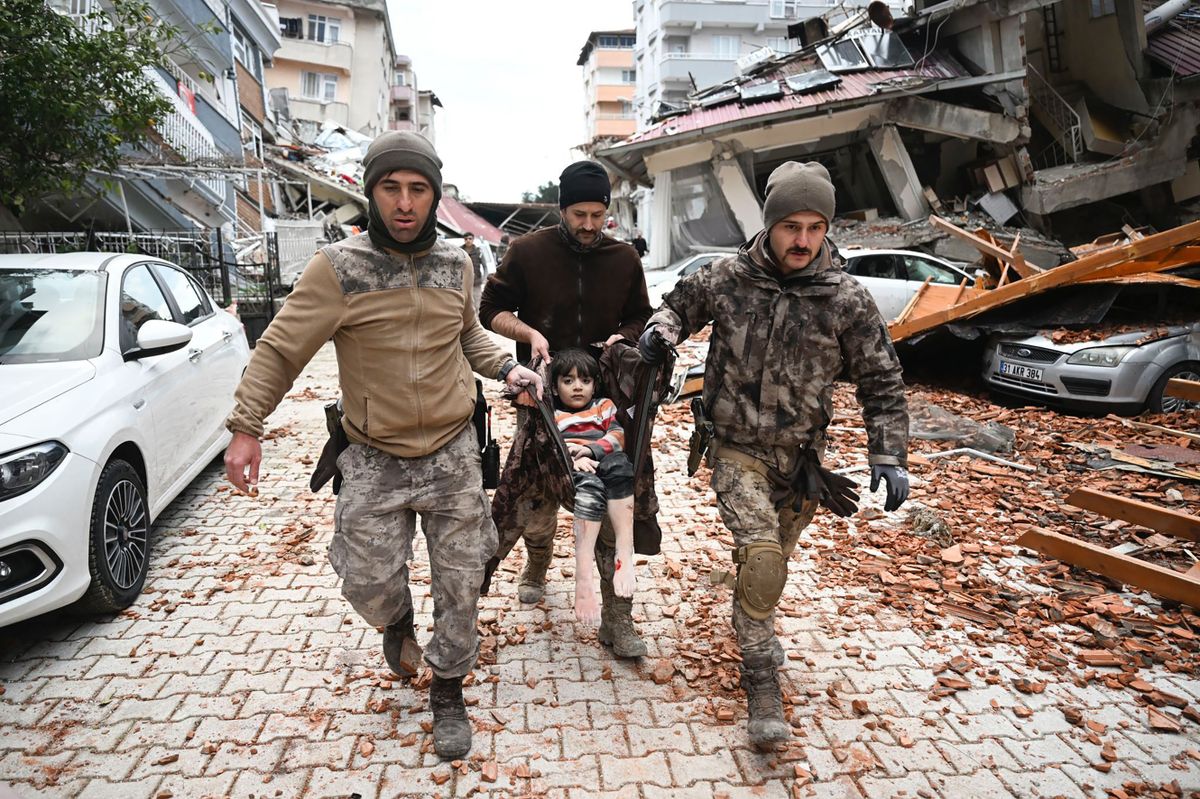 HATAY, TURKIYE - FEBRUARY 7: Turkish police special forces carry a child rescued alive from rubble of a collapsed building in Hatay after 37 hours of 7.7 magnitude earthquake hit multiple provinces of Turkiye on February 7, 2023. Early Monday morning, a strong 7.7 earthquake, centered in the Pazarcik district, jolted Kahramanmaras and strongly shook several provinces, including Gaziantep, Sanliurfa, Diyarbakir, Adana, Adiyaman, Malatya, Osmaniye, Hatay, and Kilis. Later, at 13.24 p.m. (1024GMT), a 7.6 magnitude quake centered in Kahramanmaras' Elbistan district struck the region. Turkiye declared 7 days of national mourning after deadly earthquakes in southern provinces. 