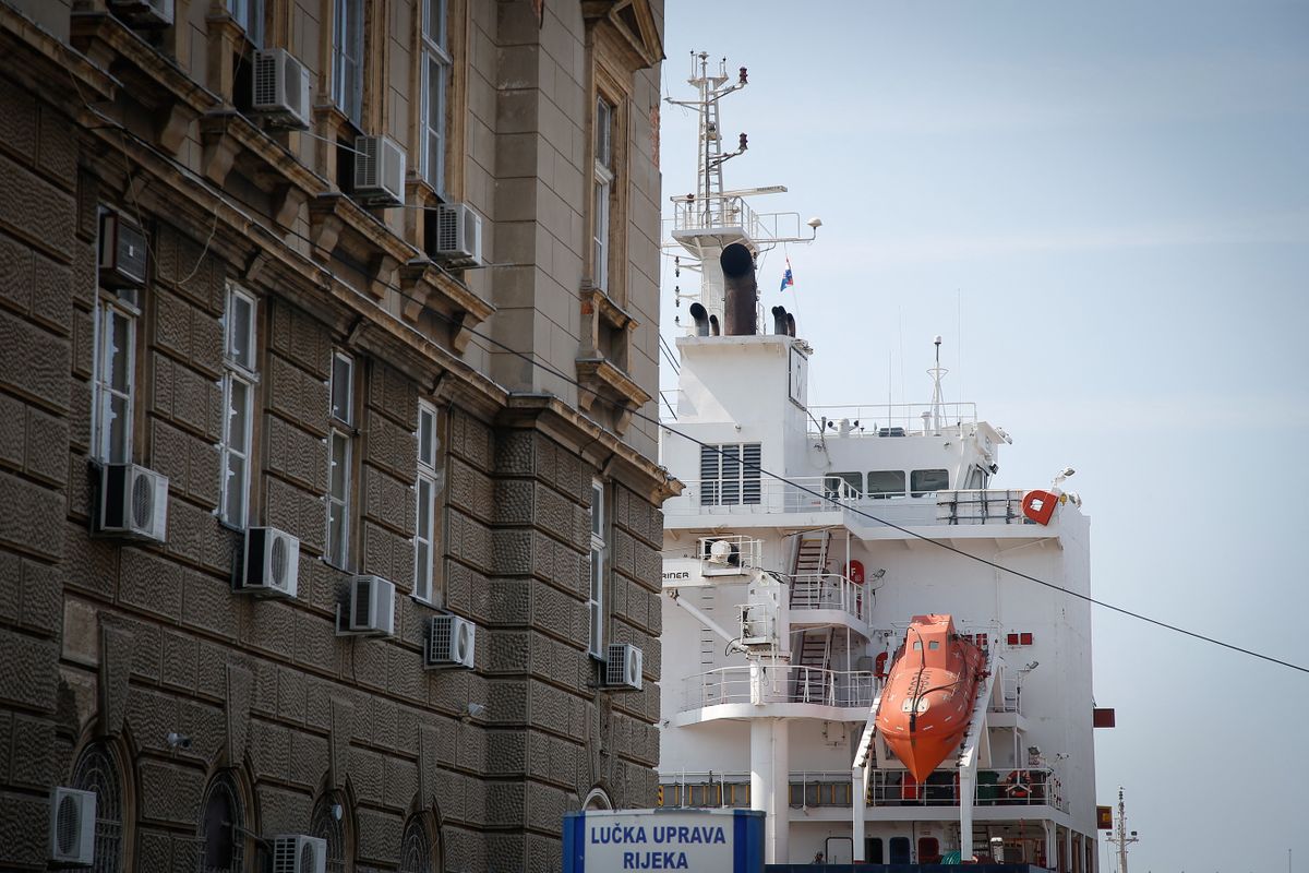 A cargo vessel is seen in the port of Rijeka, Croatia behind a building in the center of the city on 23 July, 2017. 