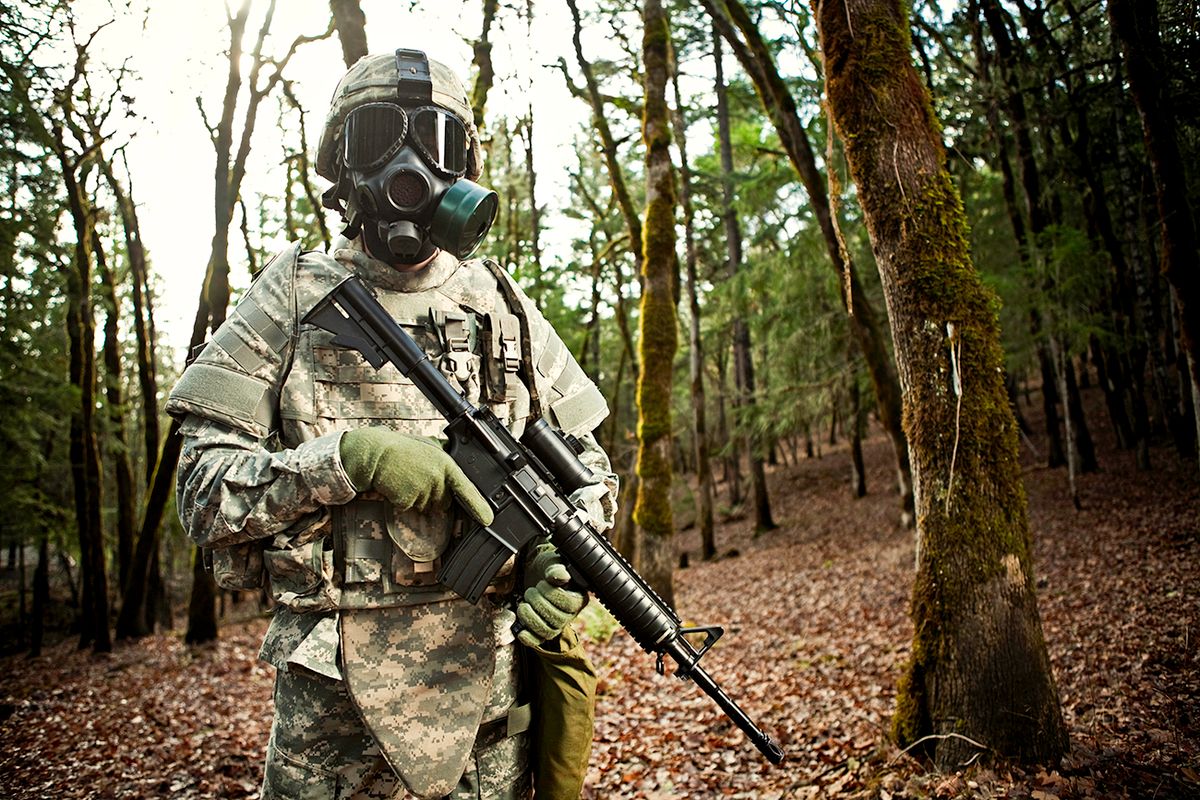 Modern Soldier in Dark Woods with Gun
A soldier stands alone wearing state of the art bullet proof body armor, camouflage, and gas mask, holding an automatic weapon.  Horizontal with copy space.
gázálarc, gázmaszk, vegyi fegyver