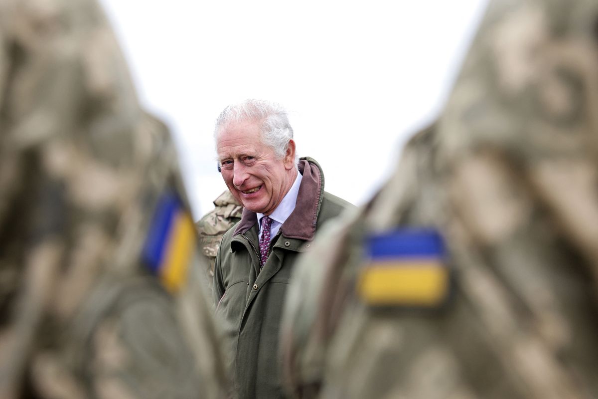Britain's King Charles III attends a site in Wiltshire where Ukrainian recruits are being trained by British and international partner forces in south-west England on February 20, 2023. - The recruits are completing five weeks of basic combat training by British and international partner forces, before returning to fight in Ukraine. 