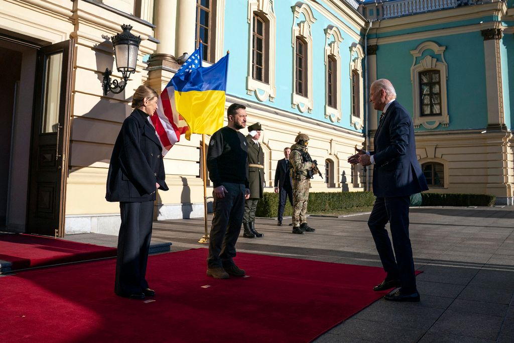 President Joe Biden (R) is greeted by Ukrainian President Volodymyr Zelensky and his wife Olena, outside Mariinsky Palace in Kyiv on February 20, 2023. - US President Joe Biden promised increased arms deliveries for Ukraine during a surprise visit to Kyiv on February 20, 2023, in which he also vowed Washington's "unflagging commitment" in defending Ukraine's territorial integrity.