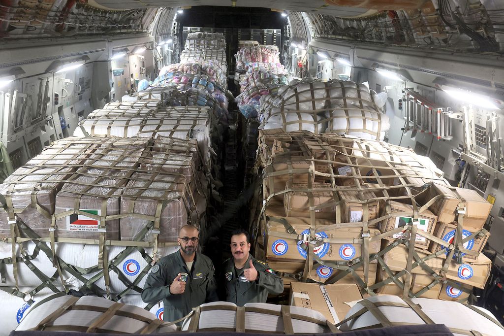 Kuwaiti army soldiers pose inside a military plane carrying humanitarian aid for Turkey following a deadly earthquake, at Kuwait international airport in Kuwait City, on February 9, 2023. - A 7.8-magnitude earthquake hit Turkey and Syria on February 6, killing more than 16,000 people and injuring tens of thousands of people. Thousands of homes were destroyed on both sides of the border after the tremor and the subsequent aftershocks. (Photo by YASSER AL-ZAYYAT / AFP)