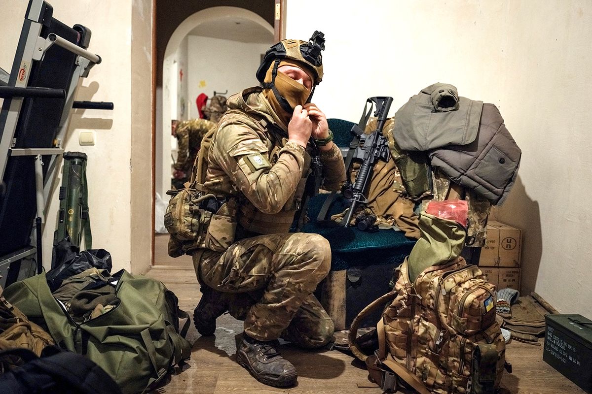 A Ukrainian serviceman prepares his equipment before leaving for the frontline, at a rest and recovery base, in the Donetsk region on February 24, 2023, on the first anniversary of the Russian invasion of Ukraine. (Photo by YASUYOSHI CHIBA / AFP)