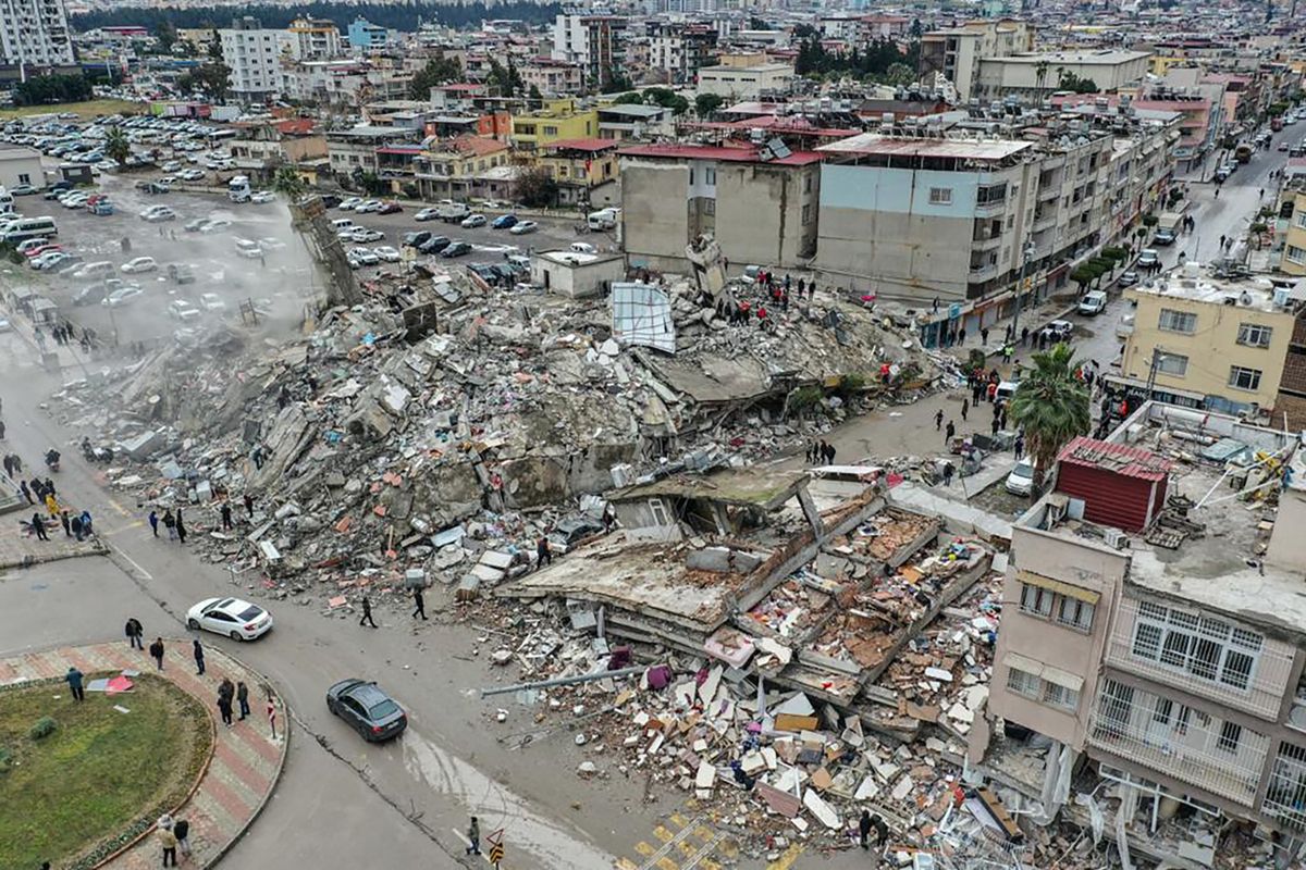 HATAY, TURKIYE - FEBRUARY 06: An aerial view of debris of a collapsed building after 7.7 magnitude earthquake hits Hatay, Turkiye on February 06, 2023. Disaster and Emergency Management Authority (AFAD) of Turkiye said the 7.7 magnitude quake struck at 4.17 a.m. (0117GMT) and was centered in the Pazarcik district in Turkiye’s southern province of Kahramanmaras. Gaziantep, Sanliurfa, Diyarbakir, Adana, Adiyaman, Malatya, Osmaniye, Hatay, and Kilis provinces are heavily affected by the quake. Murat Sengul / Anadolu Agency 
