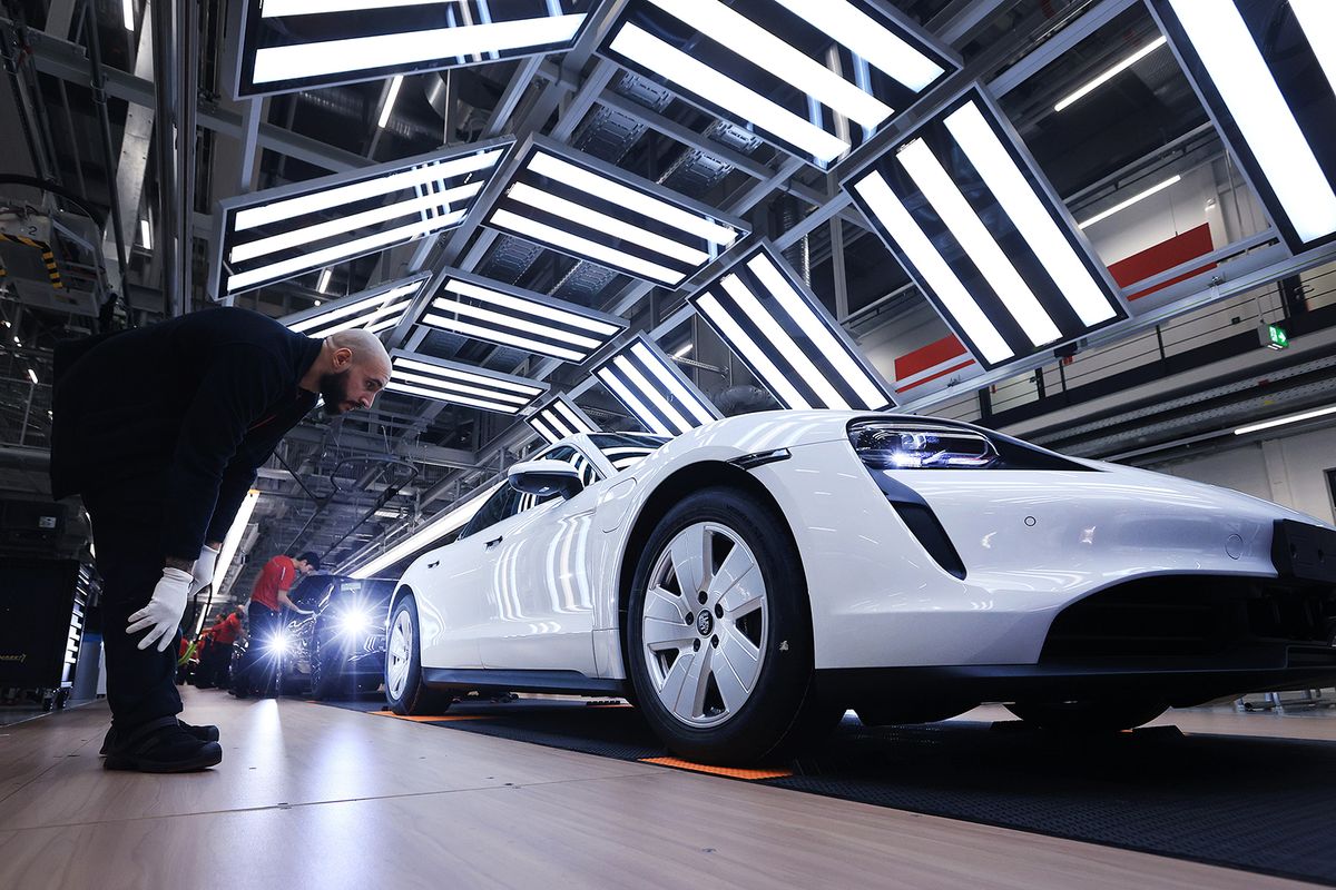Porsche AG All-Electric Taycan Sportscar Production Ahead of IPO
Employees check all-electric Porsche Taycan luxury automobiles in a light tunnel on the production line at the Porsche AG factory in Stuttgart, Germany, on Monday, Sept. 26, 2022. Volkswagen AG is likely to price the 9.4 billion-euro ($9.1 billion) initial public offering of sports-car maker Porsche AG at the top end of an initial range, demonstrating the depth of demand for its share sale. Photographer: Krisztian Bocsi/Bloomberg via Getty Images