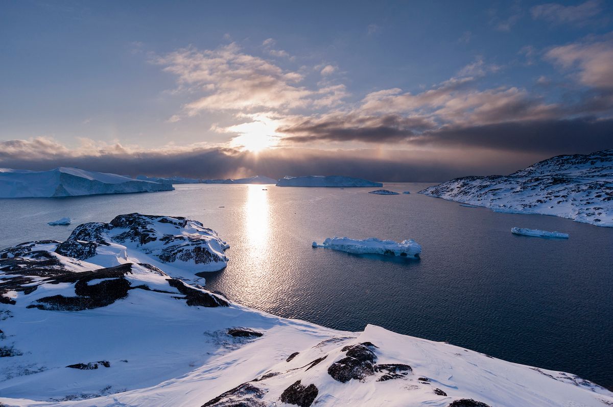 A view of Ilulissat icefjord, an UNESCO World Heritage Site, at sunset. Ilulissat Icefjord, Ilulissat, Greenland.