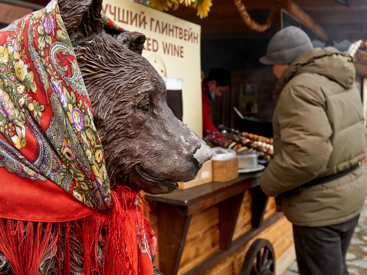 A figurine of a bear in a headscarf at a flea market in the