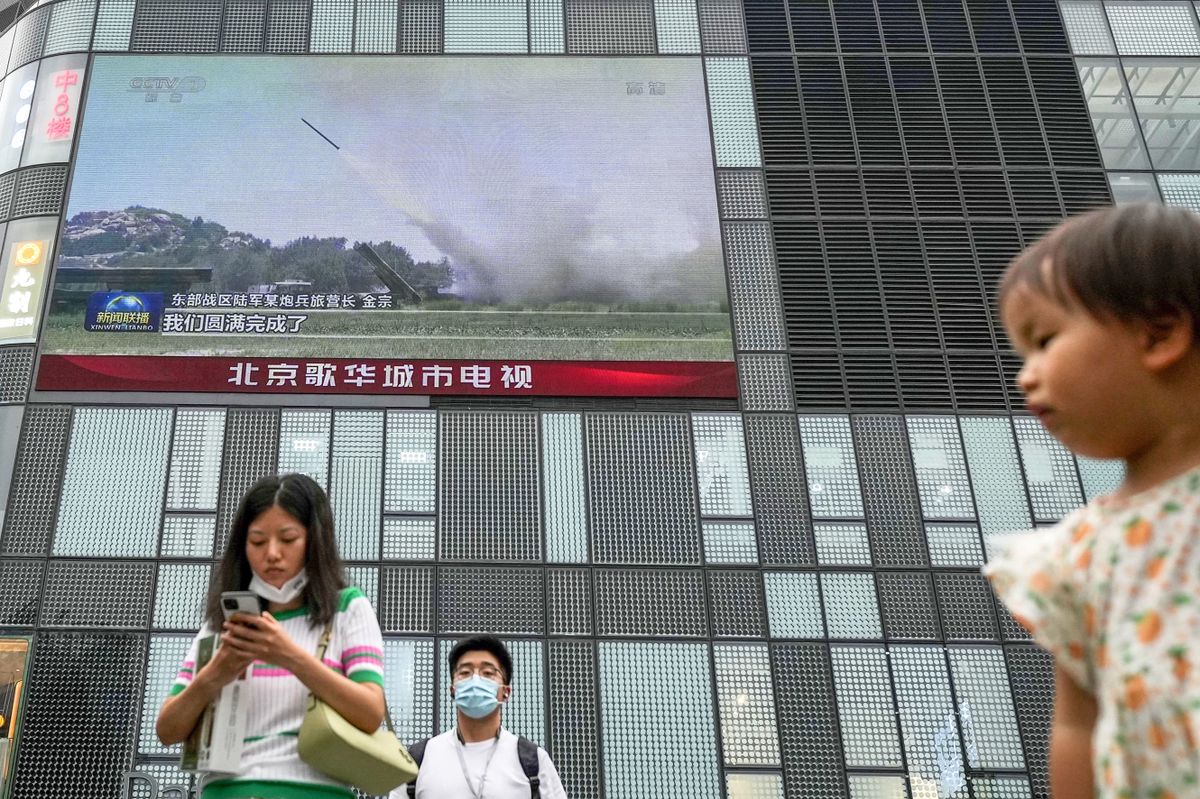 A large screen on a street in Beijing shows on Aug. 4, 2022, news that the Chinese military conducted a military drill in the strait dividing Taiwan and the mainland. The exercise is seen as a response to a recent visit by U.S. House Speaker Nancy Pelosi to Taipei. 