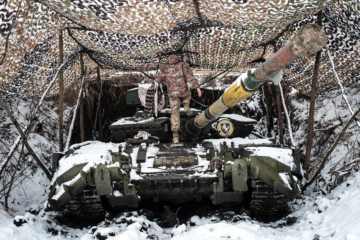 Ukrainian serviceman of the first tank brigade Igor, 26, who has worked as a gunner for four years, stands on his T-64 Main Battle Tank, near the frontline in the Donetsk region, on February 4, 2023, amid Russia's military invasion on Ukraine. (Photo by YASUYOSHI CHIBA / AFP)