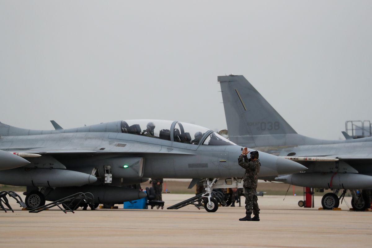 A South Korean Air Force solider directs a FA-50 Golden Eagle fighter jet, manufactured by Korea Aerospace Industries Ltd. and Lockheed Martin Corp., during the Max Thunder Air Exercise, a bilateral training exercise between the South Korean and U.S. Air Force, at a U.S. air base in Gunsan, South Korea, on Thursday, April 20, 2017. U.S. Vice President Mike Pence issued a fresh warning to North Korea from the deck of a U.S. aircraft carrier in Japan, hours after reports emerged that the approaching "armada" that President Donald Trump touted last week was still thousands of miles away. 