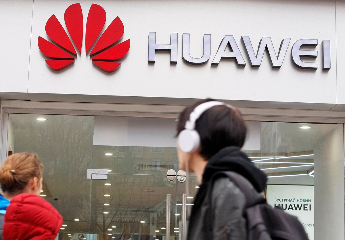 People,Walk,Past,Of,A,Huawei,Brand,Store,In,Kiev, People walk past of a Huawei brand store in Kiev, Ukraine, on 20 October 2018