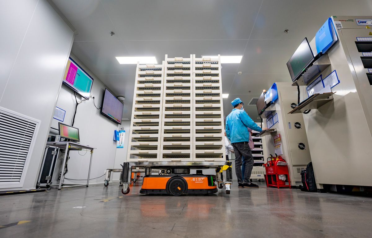 XINYU, CHINA - NOVEMBER 15: Employees work on the production line of lithium battery at a factory on November 15, 2022 in Xinyu, Jiangxi Province of China.