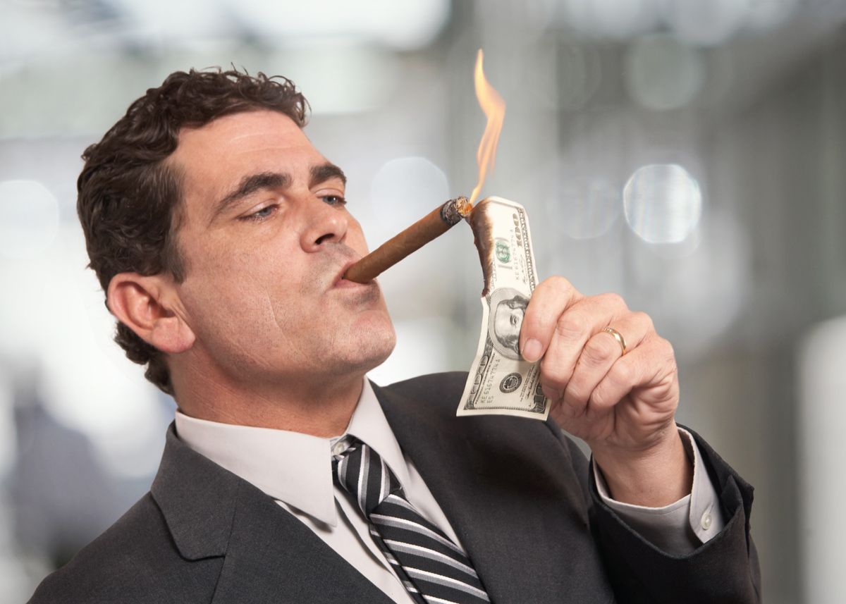 Rich,Businessman,Lighting,Cigar,With,$100,Dollar,Bill