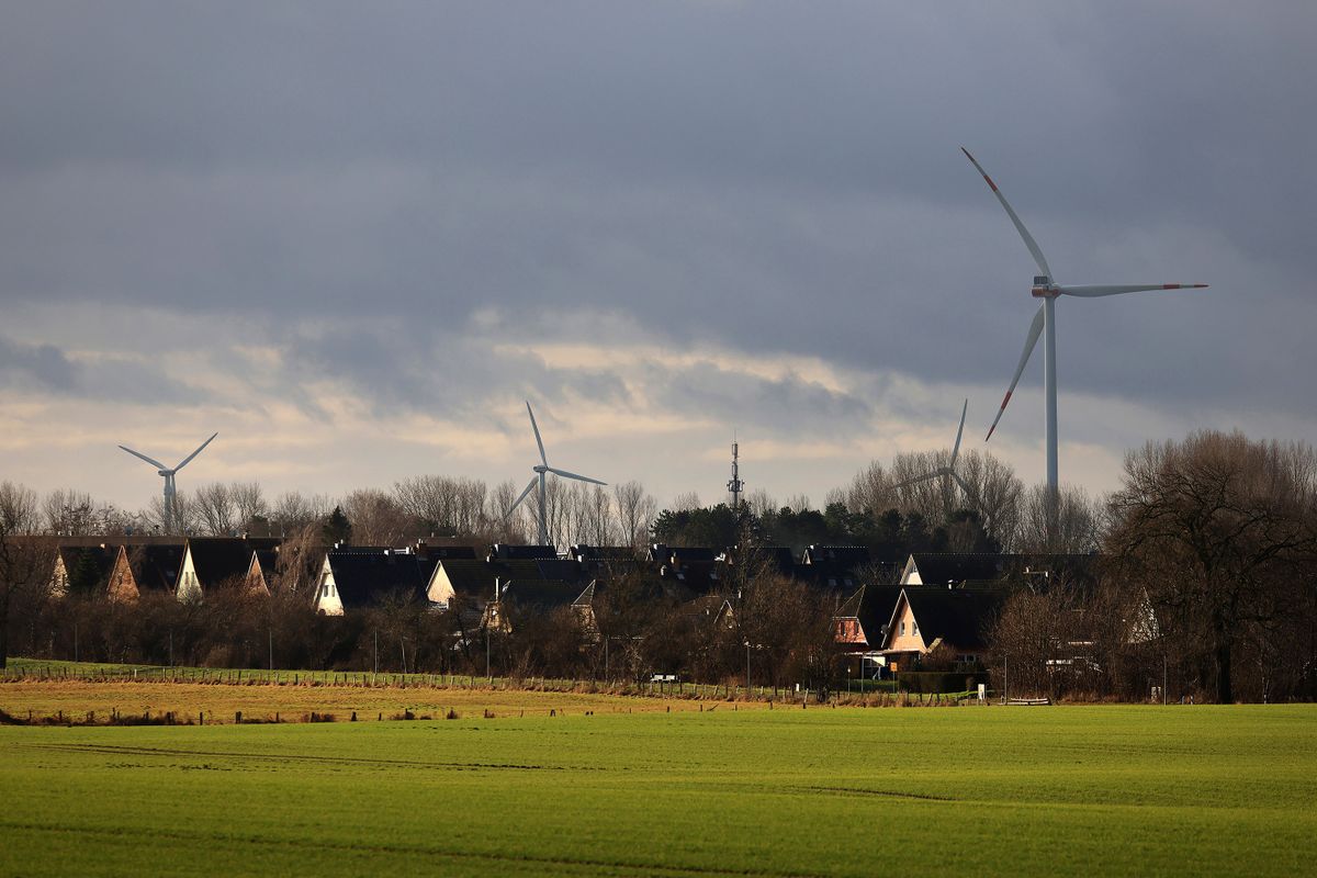 Wind turbines beyond housing near Wusterhusen, Germany, on Saturday Jan. 14, 2023. Chancellor Olaf Scholz said Germany needs to increase its pace of expanding renewable power to reach its goal of becoming climate-neutral by 2045, even as Europe's largest economy withstands the initial impact of Russia's energy squeeze. 