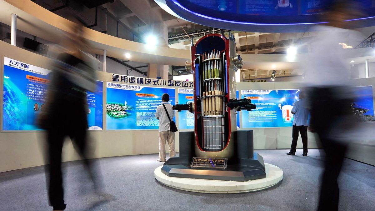 China's CGN, CNNC establish Hualong nuclear power joint venture
--FILE--Visitors walk past a model of a multi-purpose small modular reactor on display at the stand of CNNC (China National Nuclear Corporation) during the 15th China Beijing International High-Tech Expo in Beijing, China, 25 May 2012.China's two biggest state-owned nuclear power operators announced a joint venture to export the country's third-generation nuclear power reactors internationally. A ceremony took place Thursday (17 March 2016) morning in Beijing at Hualong International Nuclear Power Technology Co.'s new headquarters, China General Nuclear Power Corp. said in an e-mailed statement. The company is an equal joint venture between CGN and China National Nuclear Corp. to develop and export the home-grown Hualong One reactor overseas, it said. CGN and CNNC signed a framework agreement in December to merge their Hualong One reactor designs and jointly market the technology internationally. China plans to build around 30 nuclear power units in countries along its "Belt and Road" initiative by 2030, CNNC chairman Sun Qin said in March. China has approved construction of six Hualong One reactors within the country, according to CGN. (Photo by Stringer / Imaginechina / Imaginechina via AFP)