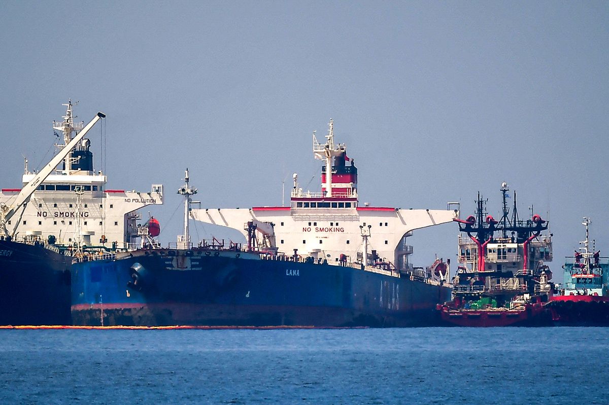 The Liberian-flagged oil tanker Ice Energy (L) transfers crude oil from the Russian-flagged oil tanker Lana (R) (former Pegas), off the shore of Karystos, on the Island of Evia, on May 29, 2022. - Greece will send Iranian oil from a seized Russian-flagged tanker to the United States at the request of the US judiciary, Greek port police said Wednesday, a decision that angered Tehran. Last month the Greek authorities seized the Pegas, which was said to have been heading to the Marmara terminal in Turkey. The authorities seized the ship in accordance with EU sanctions introduced after Russia invaded Ukraine in February. (Photo by Angelos Tzortzinis / AFP)