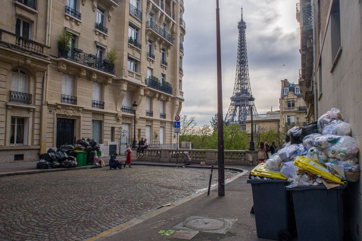 Uncollected garbage bins and bags of trash on a street, near the Eiffel Tower, during a strike by sanitation workers, in central Paris, France, on Tuesday, March 28, 2023. French unions are holding a new day of nationwide strikes Tuesday to try to force President Emmanuel Macron to reverse his decision to push through unpopular pension reforms. 