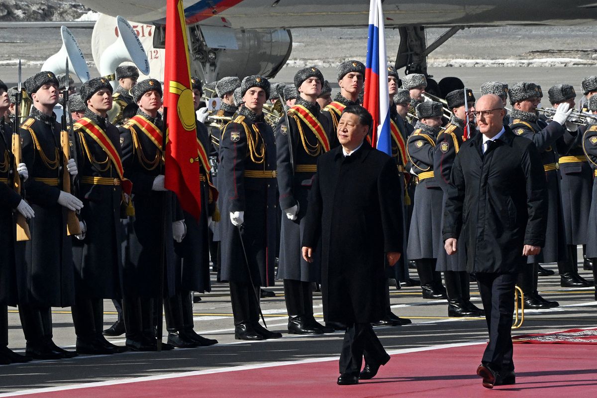 China's President Xi Jinping, accompanied by Russian Deputy Prime Minister Dmitry Chernyshenko, walks past honour guards during a welcoming ceremony at Moscow's Vnukovo airport on March 20, 2023. - Chinese leader arrived in Moscow on Monday saying his first state visit to Russia since the Ukraine conflict broke out would give "new momentum" to bilateral ties. (Photo by Anatoliy Zhdanov / Kommersant Photo / AFP) / Russia OUT
Hszi