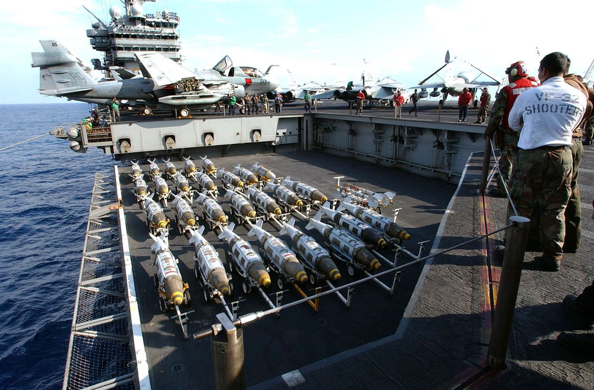 Air Campaign Continues In Iraq
AT SEA - MARCH 21:  In this Navy handout photo, 2000 pound GBU-31 Joint Direct Attack Munitions (JDAM) are transported to the flight deck of the USS Harry S. Truman March 21, 2003 in the Mediterranean Sea. The bombs will be loaded onto fighter jets to support the war in Iraq.  (Photo by U.S. Navy/ Michael W. Pendergrass/Getty Images)