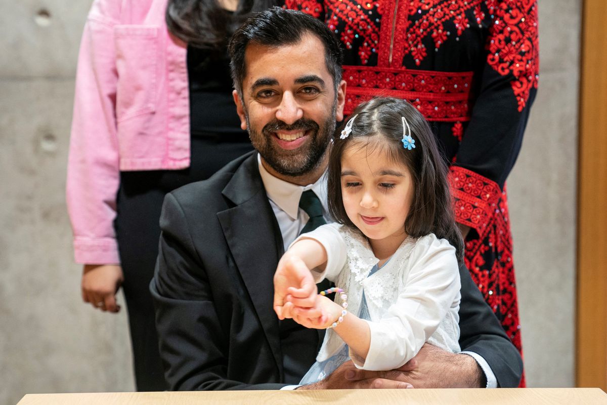 Newly elected leader of the Scottish National Party, Humza Yousaf (L) poses with his daughter Amal (R) after signing the nomination form to become First Minister for Scotland, at the Scottish Parliament in Edinburgh, on March 28, 2023 ahead of the MP's vote concerning his nomination to be Scotland's sixth First Minister. (Photo by / POOL / AFP)