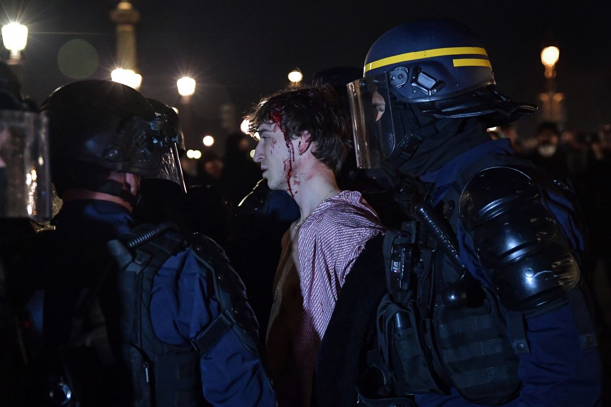 PARIS, FRANCE - March 16: (EDITORS NOTE: Image depicts graphic content)  Riot police arrest a proterster as clashes take place during a demonstration against French government's plan to raise the legal retirement age in Paris, on March 16, 2023.