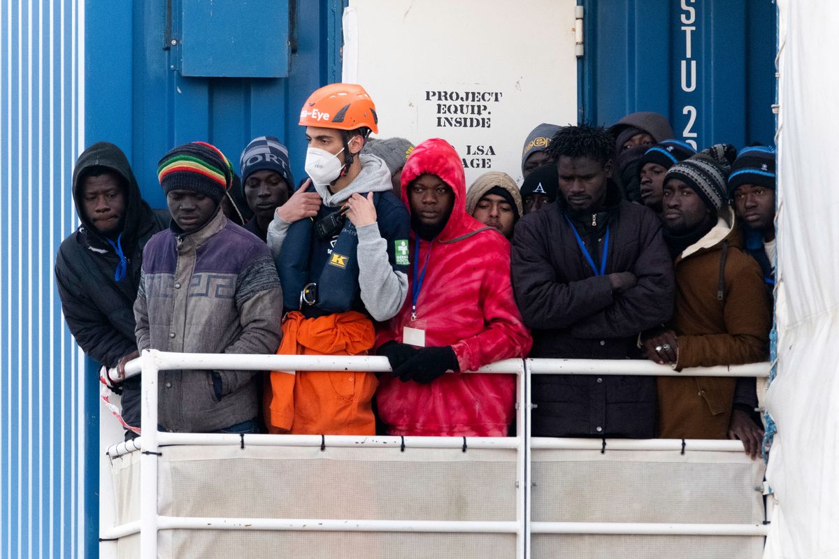 Migrants rescued in the Mediterranean sea wait to disembark from the German rescue ship Sea-Eye 4 in the port of Naples, Southern Italy, on February 6, 2023. The Sea-Eye 4 rescued in the Mediterranean sea 109 migrants including 35 minors, 22 unaccompanied and 18 women, one of whom was pregnant. 