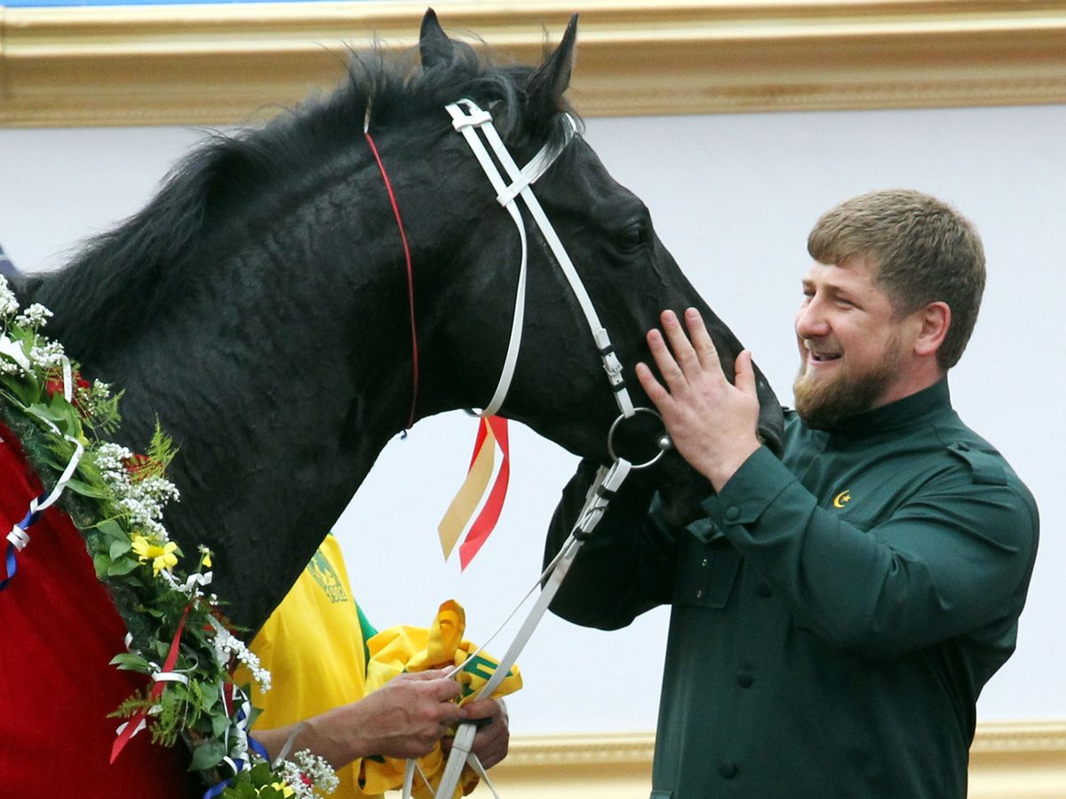 ROSTOV-ON-DON, RUSSIA - JUNE 1:  Chechen President Ramzan Kadyrov (R) pets his horse Khorezm having watchede as it raced to victory in prestigious 2,400-meter President of the Russian Federation Prize race on June 1, 2010 in Rostov-on-Don, Russia. President Kadyrov attended the meeting with his cousin Adam Delimkhanov who has been accused by Dubai police of having been behind the assassination of exiled Chechen leader Sulim Yamadayev, a political and clan rival. Russian constitutional law means that Delimkhanov is unlikely to face extradition to the United Arab Emirates or prosecution in Russia.  