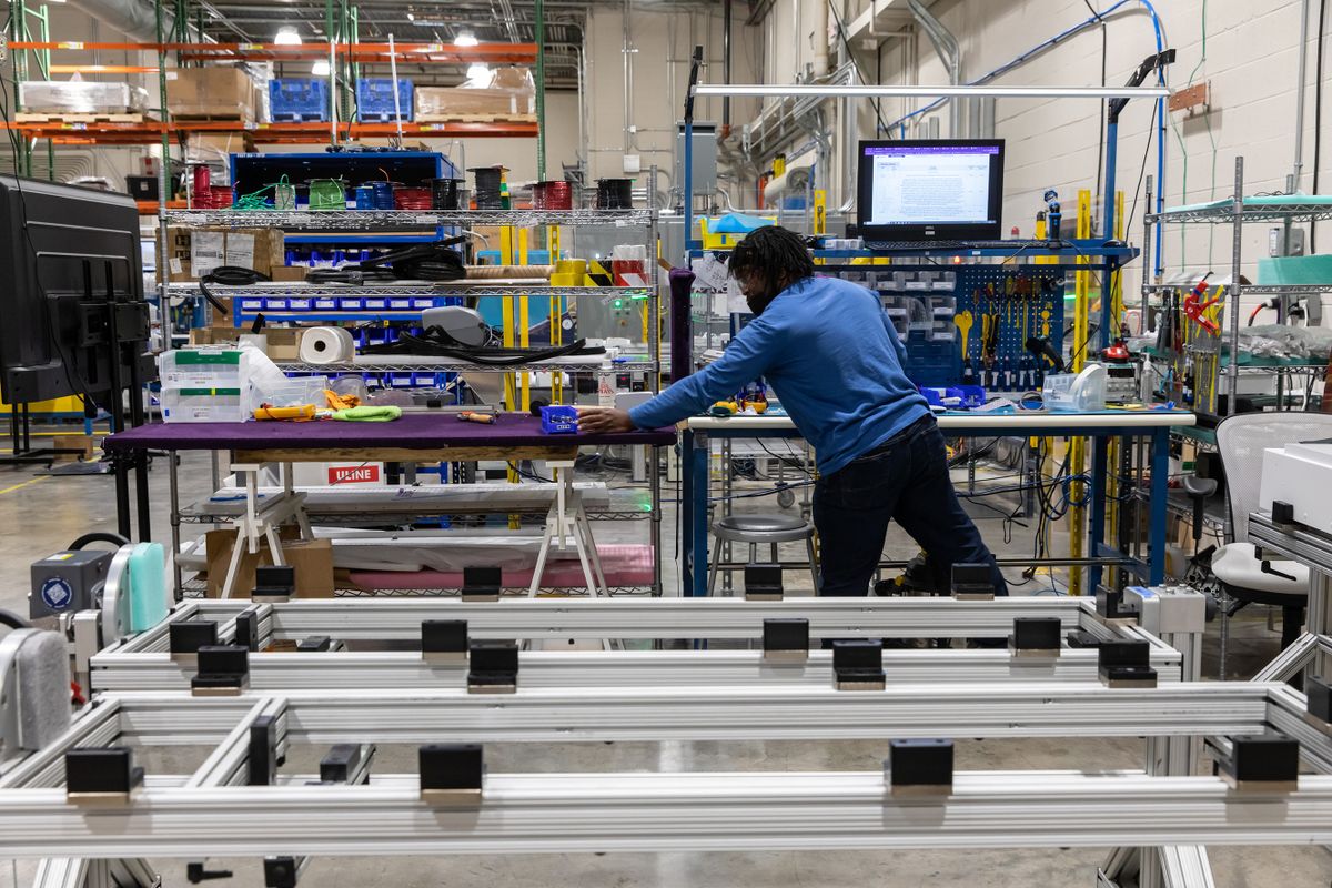 An employee at a workstation on the assembly line at the Atom Power headquarters in Huntersville, North Carolina, US, on Friday, Jan. 27, 2023. Atom Power says its smart circuit breaker will make charging electric cars as cheap and easy as using Wifi. 