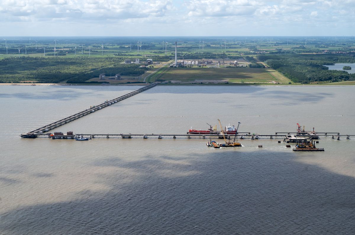 WILHELMSHAVEN, GERMANY - JULY 16: In this view from an airplane a terminal for connecting floating stations for liquified natural gas (LNG) stands under construction on July16, 2022 near Wilhelmshaven, Germany. The terminal will allow the docking of floating storage and regasification units (FSRU), which are ships that can convert liquified natural gas back into gas form and then deliver it directly into Germany's gas network and storage system. Natural gas from the Wilhelmshaven terminal will be sent through a 30km pipeline, also currently under construction, to the Etzel underground storage facility. The new terminal, scheduled for completion by the end of this year, will allow Germany to import LNG by ship from countries including the USA and Qatar in order to lower Germany's reliance on gas imports from Russia. 