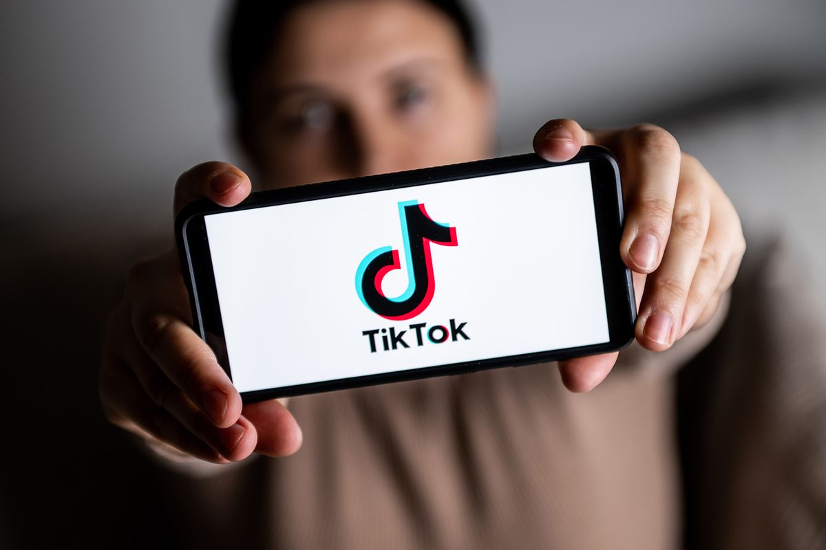 In this photo illustration a TikTok logo is seen displayed