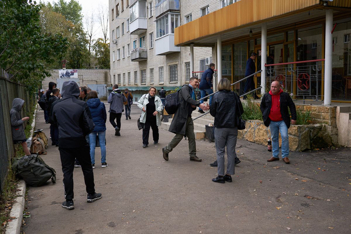 VORONEZH, RUSSIA - 2022/09/26: People seen at the entrance to the military enlistment office during mobilization in Voronezh. On February 21, Russian President Vladimir Putin signed a decree on the so-called partial mobilization. According to this document, almost all men aged 18 to 65 can be called up for military service. Some of these people can be sent directly to the war with Ukraine. Along with protests against the mobilization, many Russian citizens greeted this decree with enthusiasm. In Voronezh, almost every day, groups of people gather in the military registration and enlistment offices, ready to go to serve. In the military registration and enlistment office of the Comintern district, a line of mobilized men even formed, since the institution was not ready to work in the new conditions.