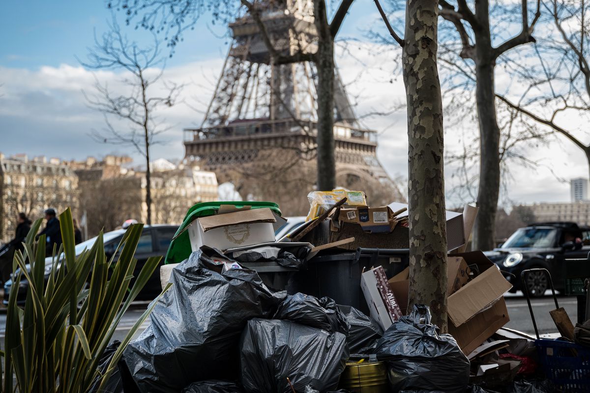 PARIS, FRANCE - MARCH 14: Piled up rubbish bags are left on the street in front of to Eiffel Tower, during the garbage collectors' strike on March 14, 2023 in Paris, France. On the ninth day of the garbage collectors' strike against the pension reform, garbage cans are piling up in Paris, dozens of filled garbage bags are piled up in the middle of the street. On tuesday, the town hall of Paris counted more than 5,600 tons of uncollected waste.  )