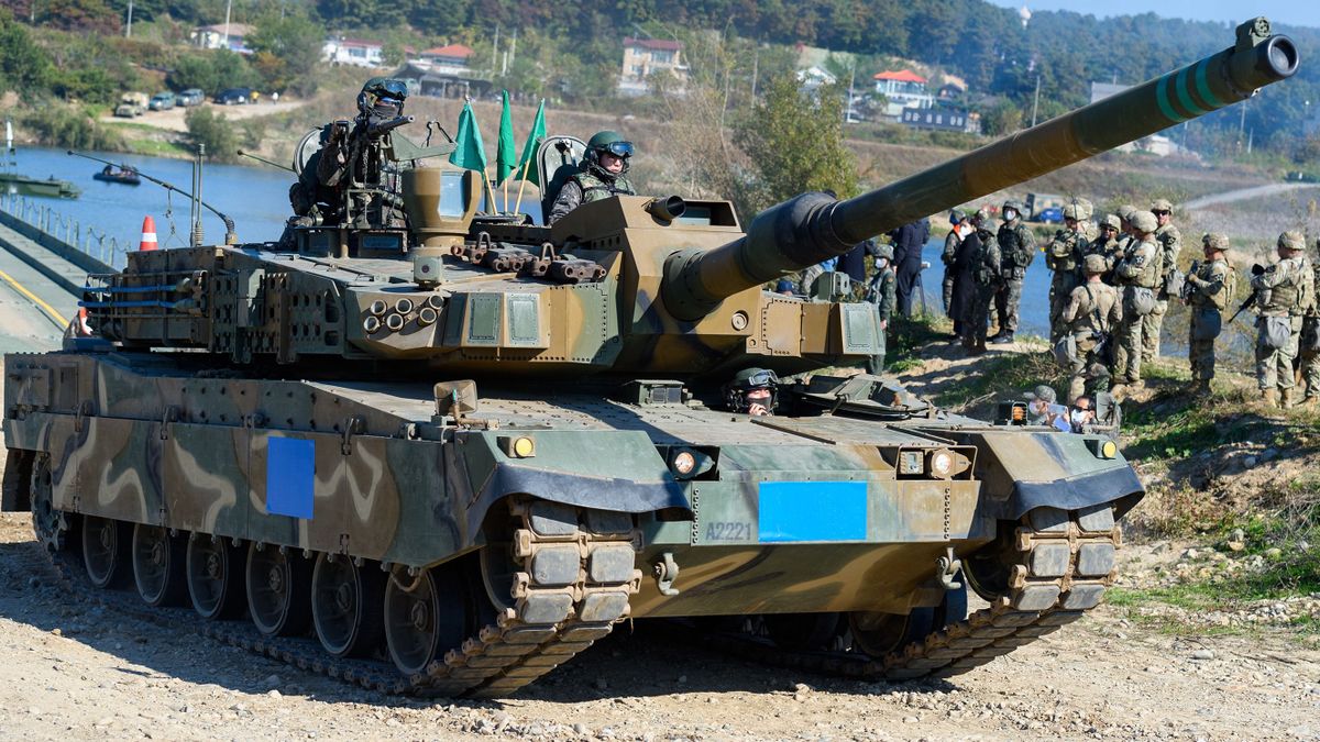 YEOJU, SOUTH KOREA - 2022/10/19: A South Korean Army K-2 tank crosses a floating bridge during a South Korea-US joint river-crossing drill as part of the annual Hoguk military exercise in Yeoju. North Korea's military warned South Korea to halt what it calls "provocations in frontline areas," having again fired hundreds of artillery shots into maritime buffer zones near their border in response to field drills under way in the South. 