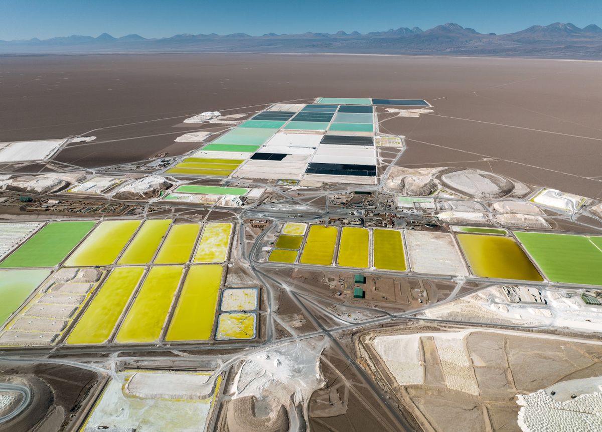SALAR DE ATACAMA, CHILE - AUGUST 24: In this aerial view, pools of brine containing lithium carbonate and mounds of salt bi-product stretch through a lithium mine in the Atacama Desert on August 24, 2022 in Salar de Atacama, Chile. Albemarle Corporation, based in Charlotte, N.C. is expanding mining operations there to meet the rising global demand for lithium carbonate, a main component in the manufacture of batteries, increasingly for electric vehicles. At the Salar Plant, natural brine is pumped from under vast salt flats to a series of evaporation ponds. During an 18-month process, the liquid s moved through 15 ponds, eventually turning from dark blue to bright yellow with a lithium concentration of 6 percent. It is then trucked to an Albemarle chemical plant in Antofagasta, where it is processed into battery grade lithium carbonate powder and shipped out internationally. The evaporation process produces large quantities of salt byproduct, much of which is then reprocessed and sold. Chile is the second largest global producer of lithium, after Australia. 