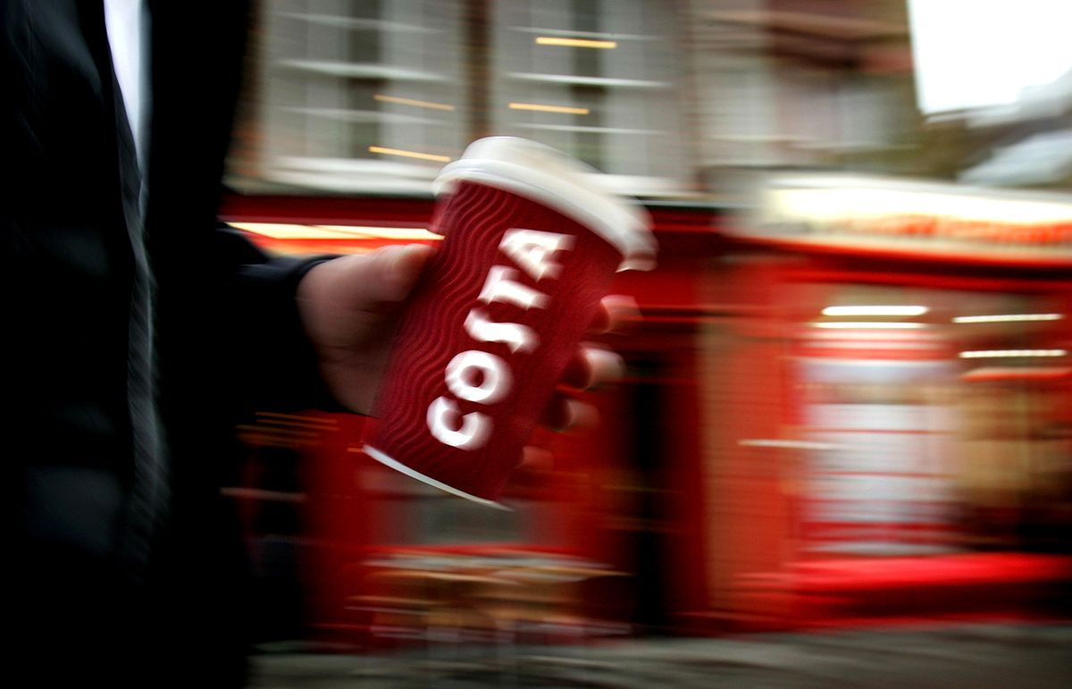 Cappuccino Culture Threatens Traditional British Breakfast
LONDON - APRIL 25:  In this photo illustration a man walks past a Costa Coffee Store in central London on April 25, 2006 in London, England. The all traditional English style Breakfast 'Fry-Up'  is under threat of being replaced by more continental style coffee shops on the High Streets.  (Photo Illustration by Daniel Berehulak/Getty Images)