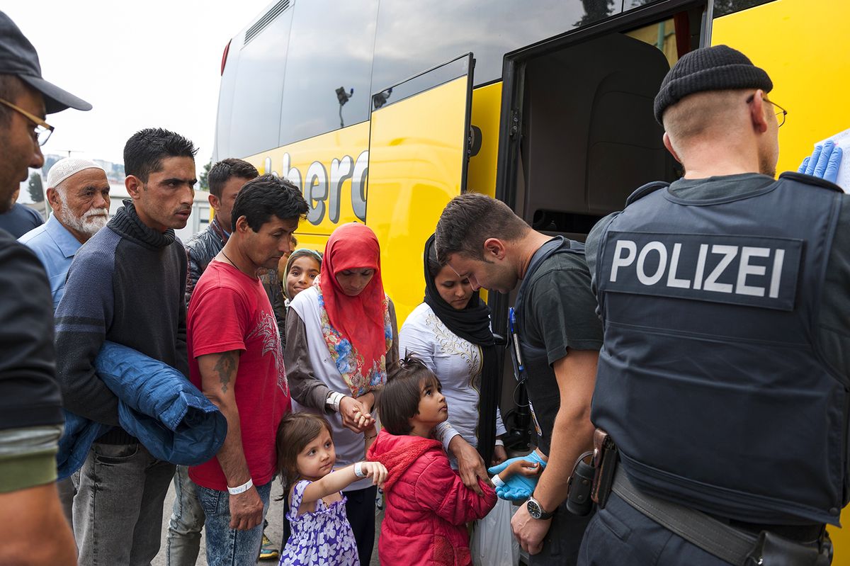 Passau,,Germany,-,August,2,,2015:,Refugee,Family,Go,Into
Passau, Germany - August 2, 2015: Refugee family go into a bus on the way from migrant registration center in Passau, southern Germany 