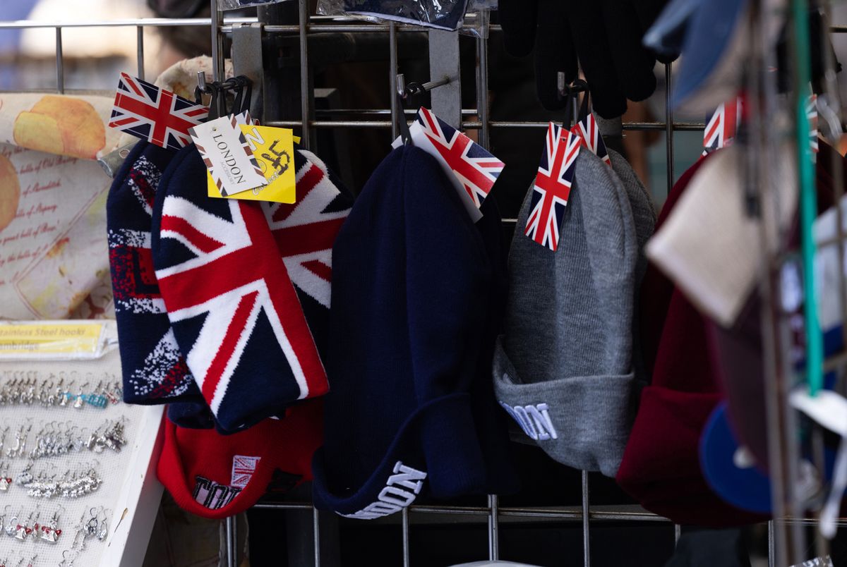 Hats decorated with the British Union flag for sale at a souvenir stall in Cambridge, UK, on Thursday, April 13, 2023. Cambridge is a crucial part of the UK's goal to become a science and technology superpower by 2030 and the university's contribution to the domestic economy is almost quadruple that of UK soccer's Premier League. Photographer: 