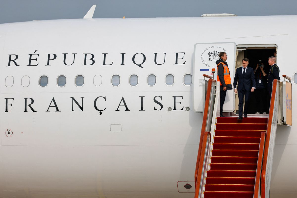 French President Emmanuel Macron (2nd L) disembarks his presidential plane at Beijing Capital International Airport in Beijing on April 5, 2023. 