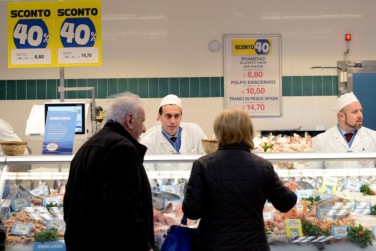ROME, ITALY - APRIL 05:  A shop assistant serves customers in the seafood section as Italian supermarket chain Esselunga opens its first store in Rome in Via Palmiro Togliatti  in Rome, Italy. The company operates 152 superstores and supermarkets across Italy. 