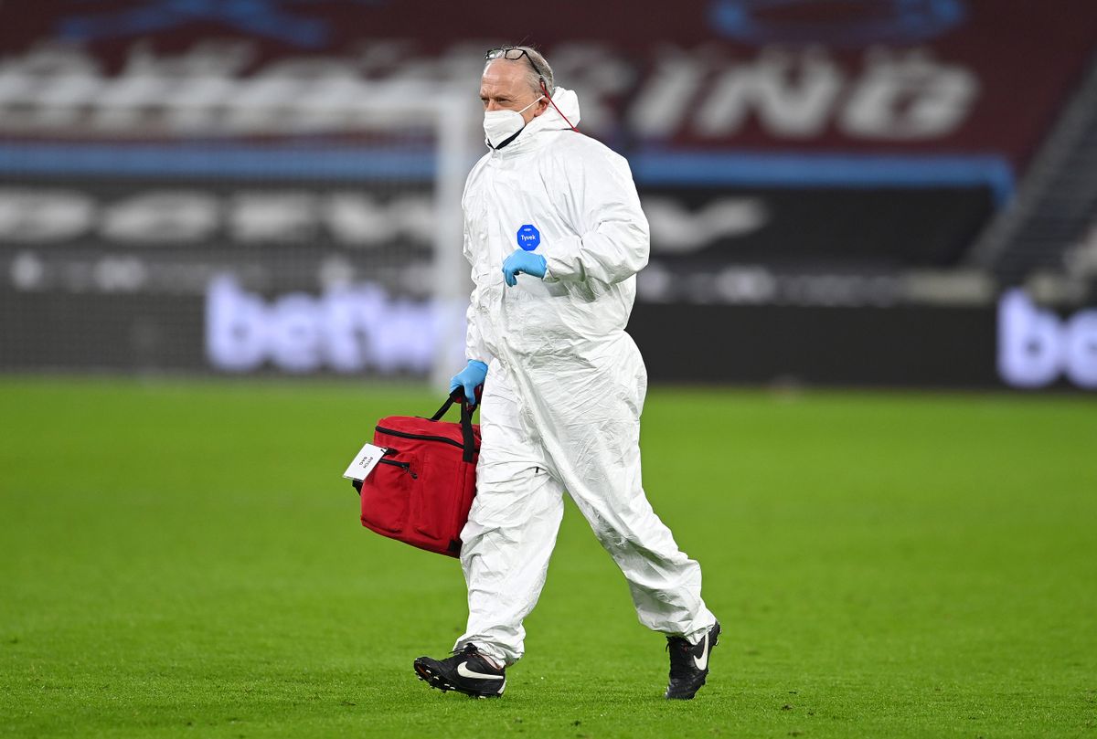 LONDON, ENGLAND - FEBRUARY 15: A member of the medical team runs on the pitch in full PPE during the Premier League match between West Ham United and Sheffield United at London Stadium on February 15, 2021 in London, England. Sporting stadiums around the UK remain under strict restrictions due to the Coronavirus Pandemic as Government social distancing laws prohibit fans inside venues resulting in games being played behind closed doors. 