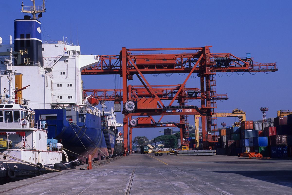 INDIA - 2000/01/30: A container ship is being unloaded in the port of Cochin in India. 